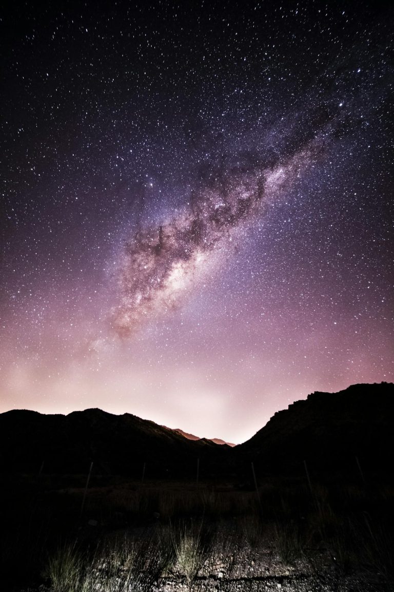 Amazing starry night sky over rocky terrain
